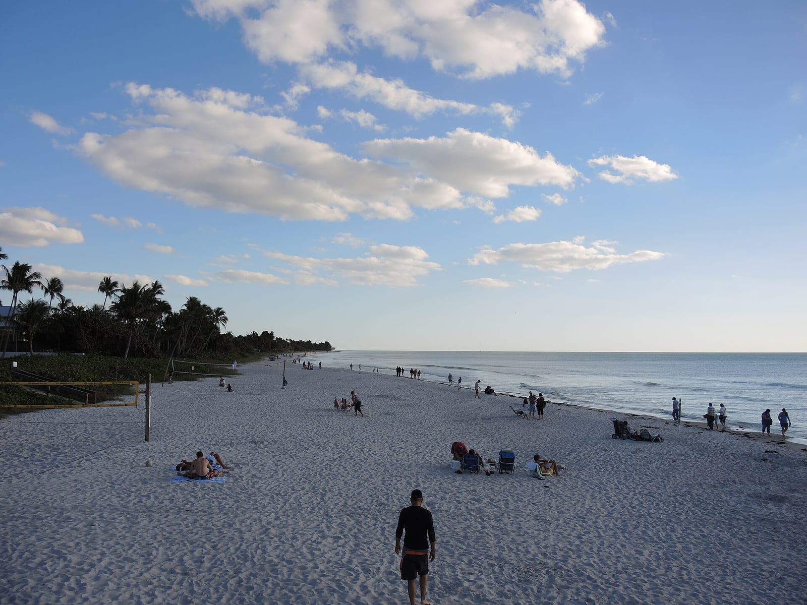 18th Avenue South Beach: sandy beach with scattered visitors, ocean, palm trees, blue sky