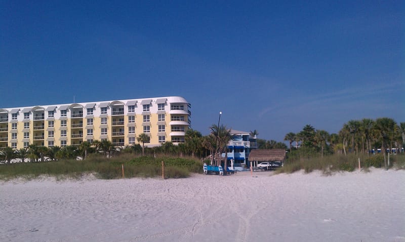 Cresent Beach: beach with sand dunes, beachfront condominium building, palm trees