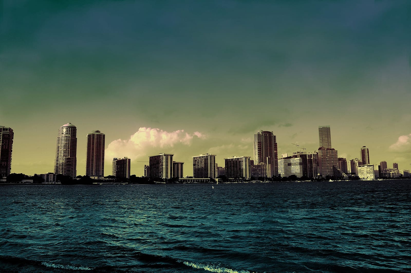 Hobie Island Beach: urban skyline viewed across calm turquoise water from sea