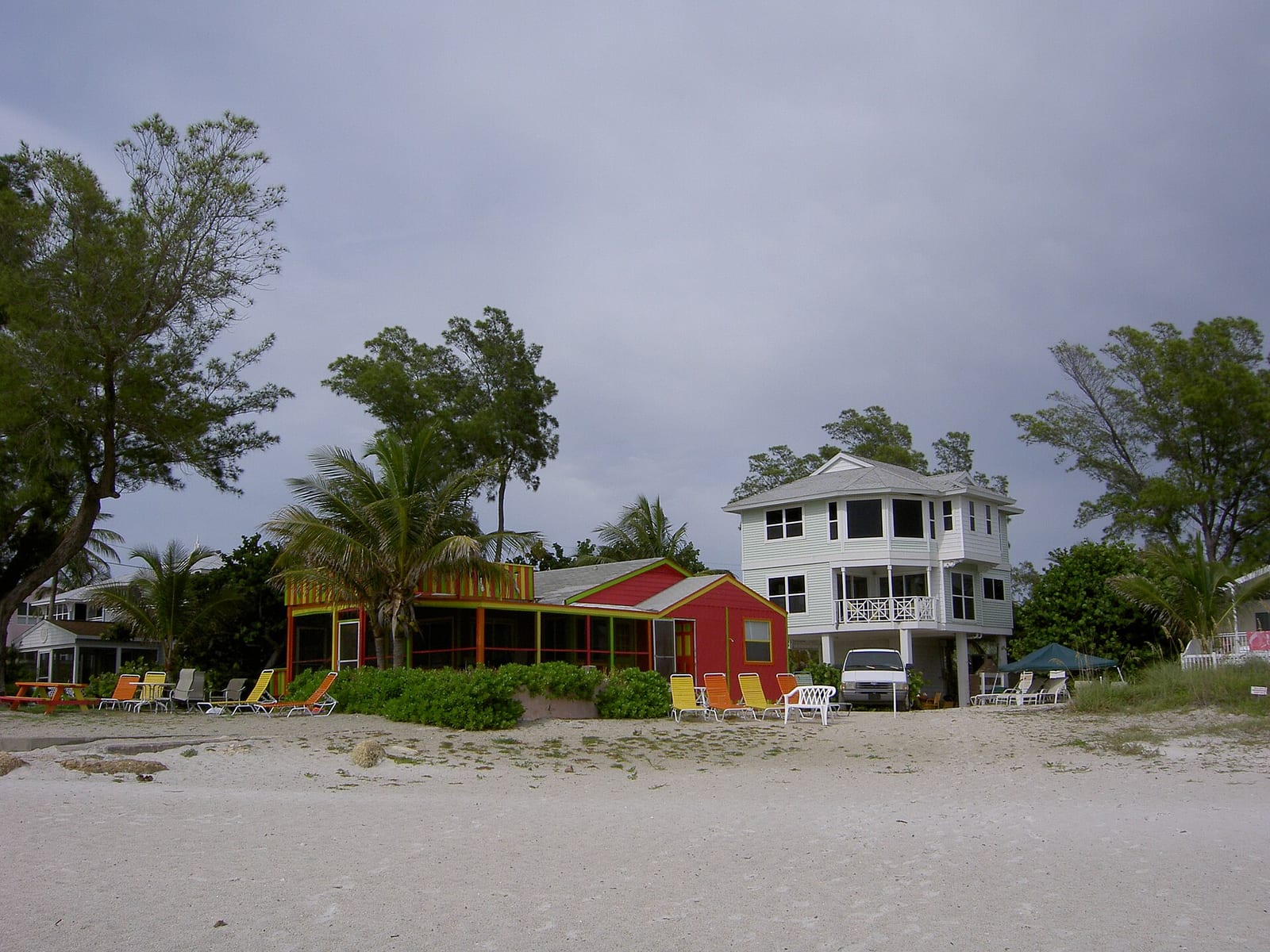 Manatee County Beach: beachfront houses and structures on sand with palm trees