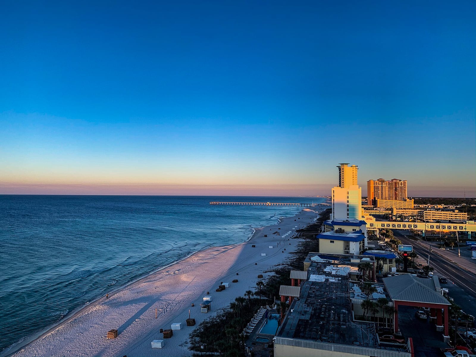Panama City Beaches: beach cityscape at sunset with high-rise hotels and pier
