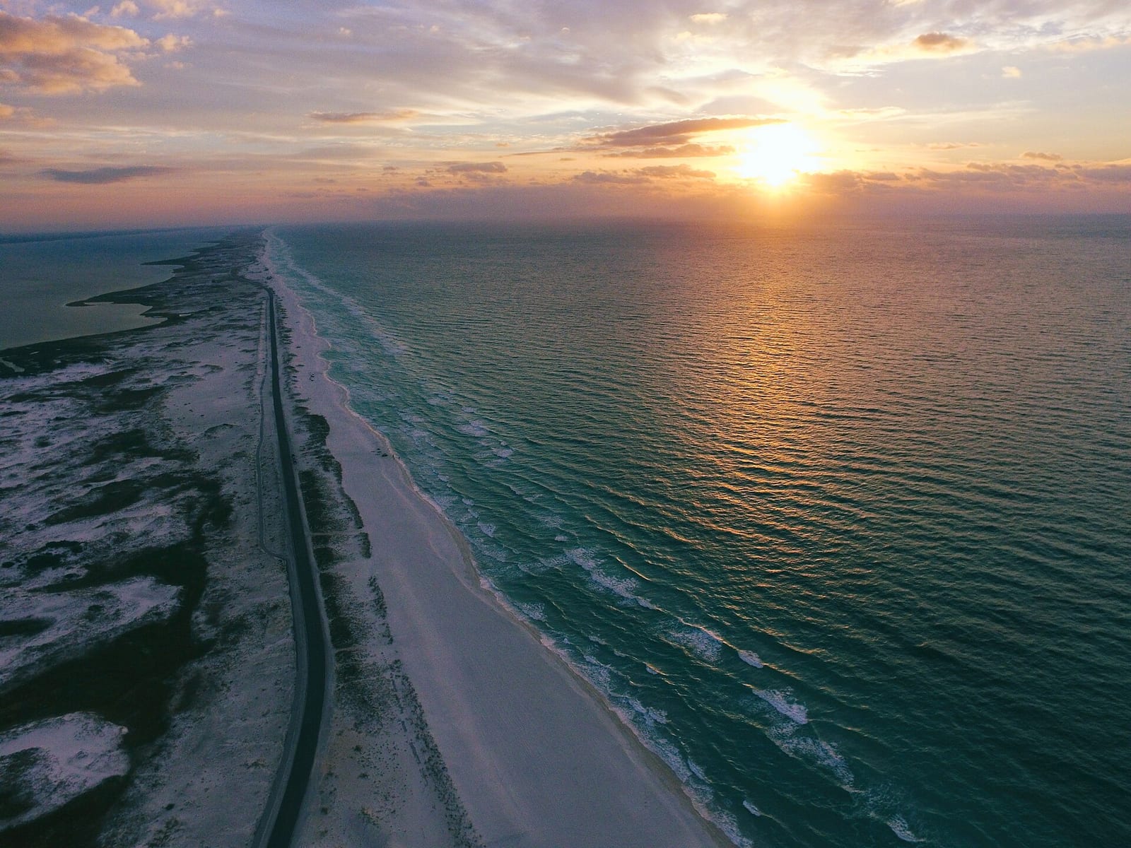 Park East On-Leash Dog Beach: aerial view of beach and road at sunset over ocean
