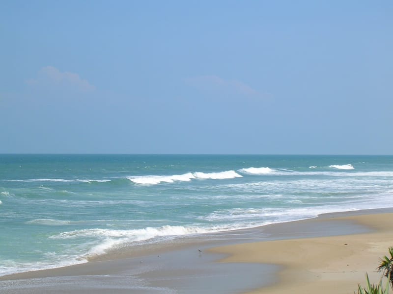 Playalinda Beach: sandy beach with ocean waves and clear blue sky