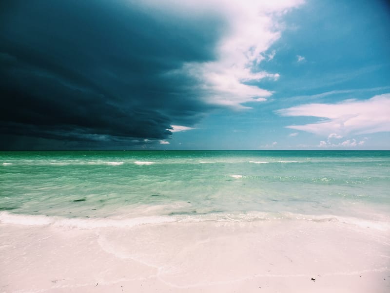 Sarasota Beach: sandy beach with turquoise water and dramatic cloudy sky