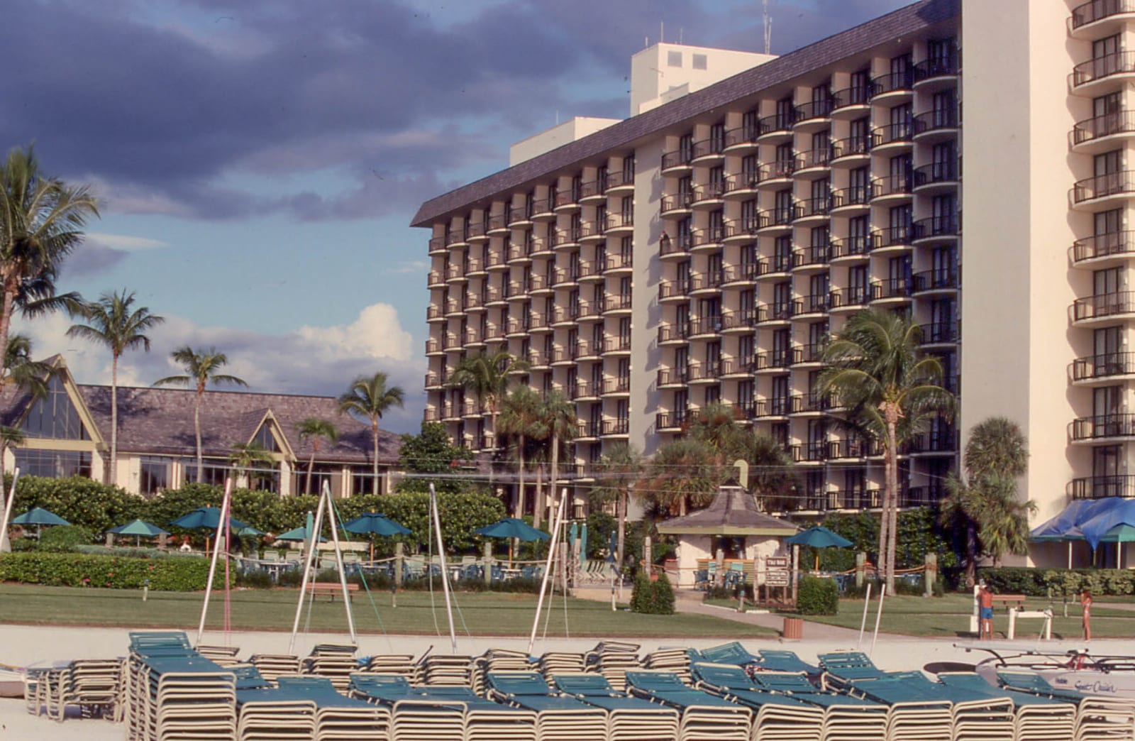 South Marco Beach: beach resort with loungers, buildings, palm trees, and manicured grounds